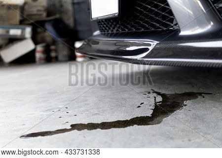 Engine Oil Stains Of Car Leak Under The Car When The Car Is Park On The Road  Service Photo Concept 