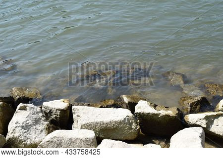 Rough Grey Shore Rocks At A River