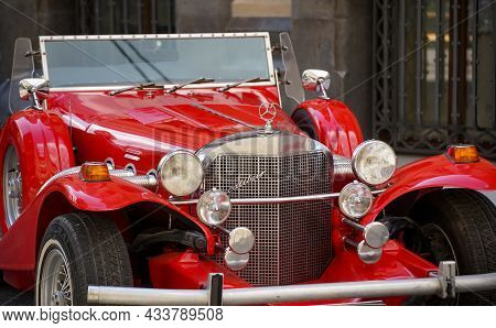 Bucharest, Romania - August 19, 2021: A Red Excalibur 1970s Ss Car Is Parked In Front Of The Marmoro