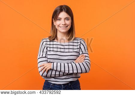 Portrait Of Cute Happy Young Woman With Brown Hair In Long Sleeve Shirt Standing With Crossed Arms A