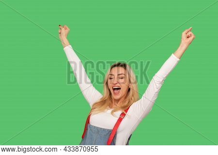 Yes I Am Winner. Portrait Of Enthusiastic Adult Woman In Stylish Denim Overalls Shouting Hurray And 