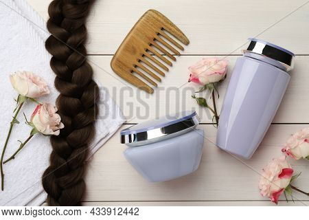 Flat Lay Composition With Natural Cosmetic Products And Hair Braid On Beige Wooden Background. Space