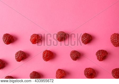 Flat Lay Composition With Red Juicy Raspberries On A Pink Background