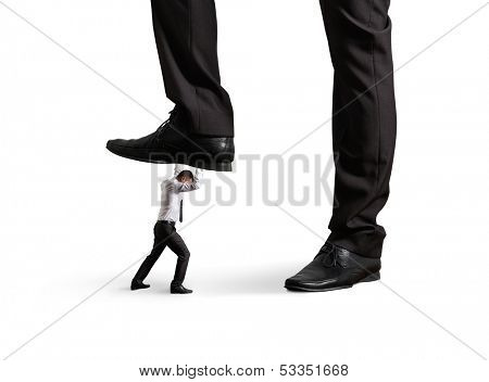 small businessman under big leg his boss. isolated on white background