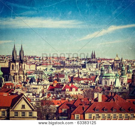 Vintage retro hipster style travel image of aerial view of Prague, Czech Republic with grunge texture overlaid