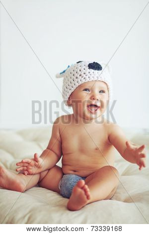 Portrait of a cute 1 year old baby dressed in a bear hat