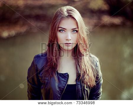 Portrait Of Young Beautiful Woman In Leather Jacket