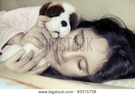 Little sweet girl sleeping and hugging her toy