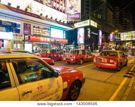 HONG KONG CHINA - OCT 22: Crowded street view at night on October 22 2015 in Hong Kong China. With 7M population and land mass of 1104 sq km it is one of the most dense areas in the world.