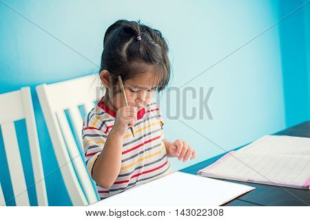 asian young girl children happy doing her homework people, family concept