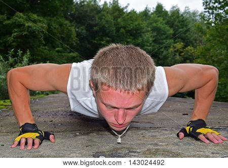 Athletic man is pushed from the floor