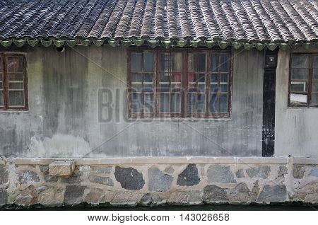 An old weathered building lining a water canal in Luzhi town in Jiangsu province china.