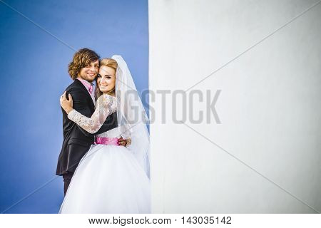 Elegant bride and groom posing together outdoors on a wedding day