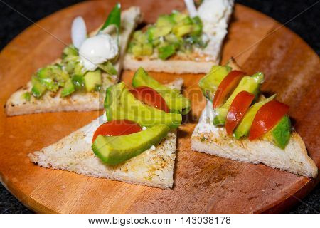 Avocado and fresh sliced tomatoes on bread