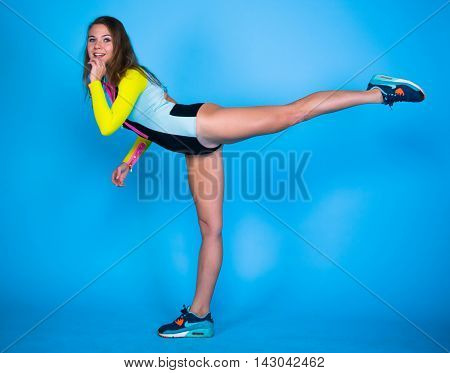 Smile sport girl posing on blue background