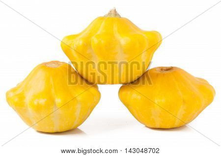 three yellow pattypan squash isolated on white background.