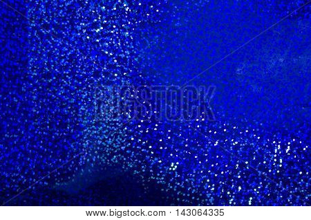 Abstract blue glitter background. Blurred shimmer bokeh. Holiday sparkle background.