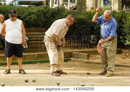 Barcelona, Spain 16 august 2016: old men playing petanque in a city park on Passeig de San Joan in Eixample