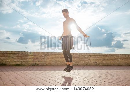 jumping rope man jump sun sunny lens flare outdoors shirtless lens flare