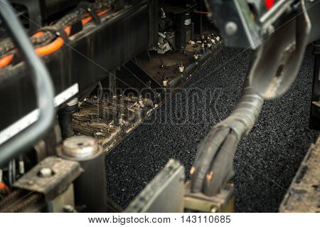 Road construction works with roller compactor machine and asphalt finisher