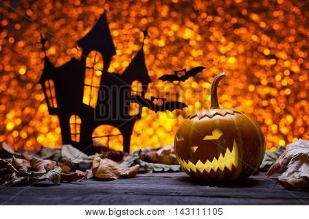 Pumpkin for Halloween, lamp pumpkin, antique wood, bat silhouette, celebrating halloween, smiley on a pumpkin, the silhouette of the castle, autumn dry leaves, bright background
