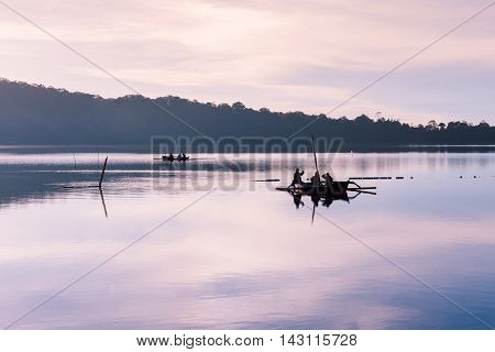 Fishermen boats on the Bratan Lake during sunrise Bedugul Bali Indonesia