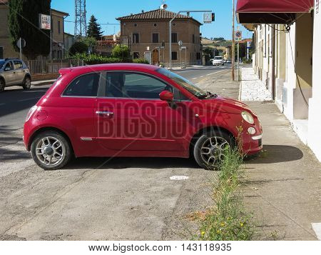 SIENA ITALY - CIRCA JULY 2016: red Fiat New 500 car parked on a street