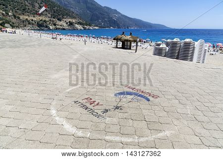 OLUDENIZ TURKEY - JUNE 04: Tourists visit Oludeniz beach in Turkey on JUNE 04 2016. Oludeniz beach is one of the best beaches in Turkey it's situated on Mediterranean Sea
