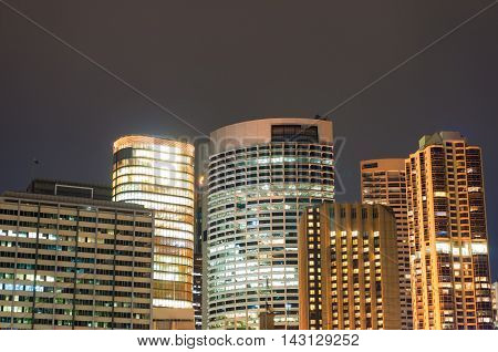 Modern cityscape at night background. Office skyscrapers of Sydney downtown at dusk. Copy space long exposure