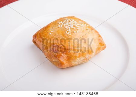 Fresh baked samosa on a white plate