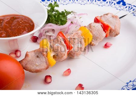 Grilled kebab skewer served with tomato sauce