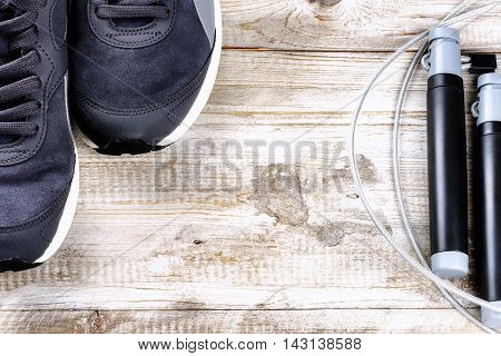 Fitness background with sneakers and skipping rope. Healthy lifestyle concept with copy space