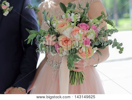Beautiful Bridal Bouquet In Hands Of The Bride. Wedding Bouquet Of Peach Roses By David Austin,  Sin