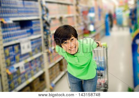 Beautiful asian woman so happy shopping in a supermarket