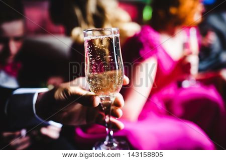 Champagne and glasses on the back seat of a limousine closeup