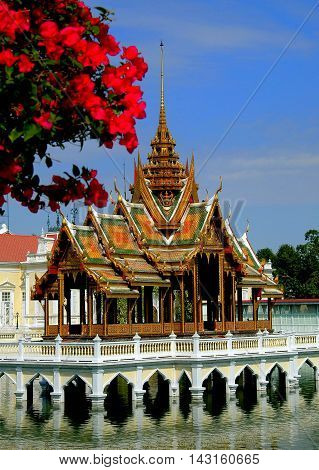 Bang Pa-In Thailand - December 28 2005: Bougainvilleas frames the Golden Pavilion Phra Thinang Aisawan Tippaya at the Royal Summer Palace