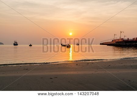 Public area sunrise at Saranvitee bridge at ao prachuab with silhouette of small fishing boat Prachuap Khiri Khan provincethailand