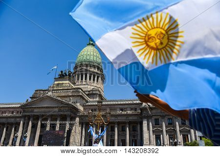 Buenos Aires Argentina - Dec 10 2015: Supporters of the newly elected Argentinean president wave flags on inauguration day at the the Congress.