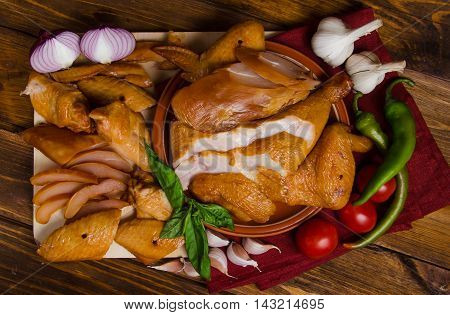 Grilled chicken set with vegetables on a wood
