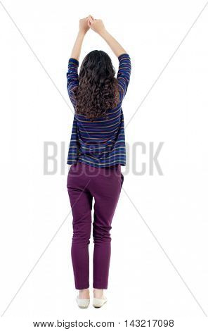 back view of dancing young beautiful  woman. girl  watching. Rear view people collection.  backside view of person.  Isolated over white background. Long-haired curly girl in a blue sweater pulls his