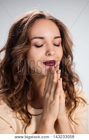 The Woman is looking imploring over gray background