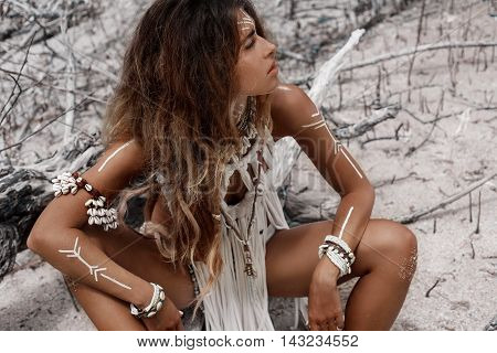 Attractive wild boho woman at beach. Native american style