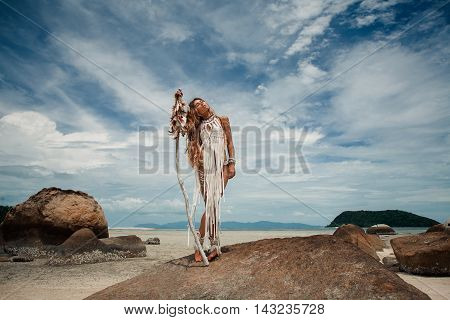 Attractive wild boho woman at beach. Native american style