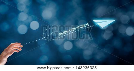 Follow your business instincts concept. Businessman throw a paper plane and text follow your instincts.