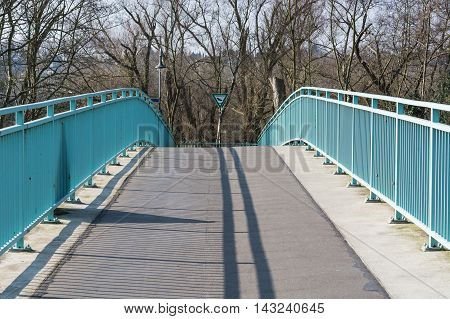 Pedestrian bridge steel arch structure over the river Ruhr in Muelheim Germany.