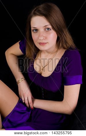Girl in a lilac dress on black background
