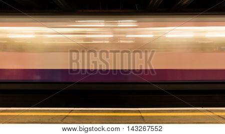 Moving train in Embankment subway station. London, UK.