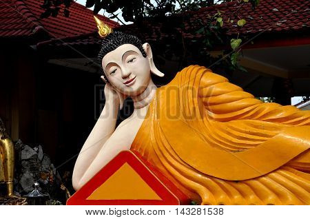 Bang Saen Thailand - January 7 2010: Reclining Buddha figure reaching Nirvana at a Kuan-Yin Chinese temple on Sam Muk Hill