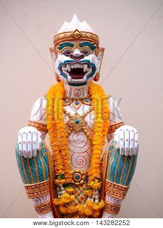 Hanuman statue with yellow garland thailand style