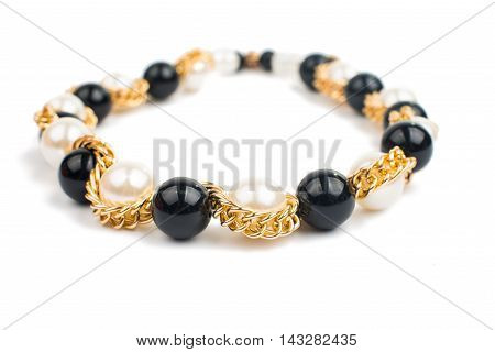 Pearl necklace over ashion  macro white background